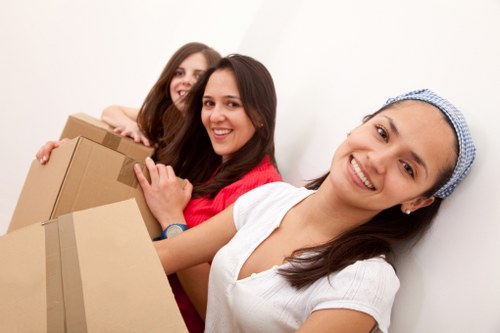 Professional movers loading furniture into a van in Finchley
