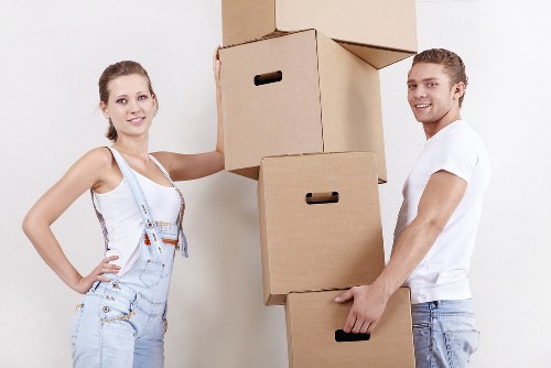 Team using safe lifting techniques with furniture